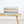 Laden Sie das Bild in den Galerie-Viewer, RIEMA XL Kuscheldecke aus recycelter Baumwolle mit Leo Muster in beige und grau auf Holzbank
